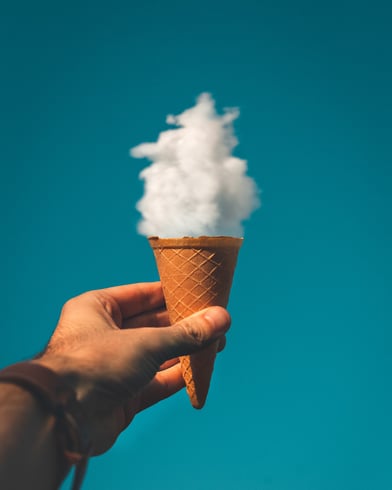 man-holding-ice-cream-cone-under-cloud-1262302